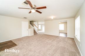 Converse house for rent - A spacious room with a fan and carpeted floor.