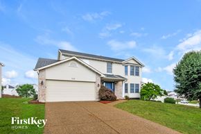 O'fallon house for rent - a white house with a driveway and a lawn