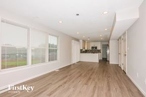 O'fallon house for rent - a spacious living room with wood floors and large windows