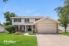 Weldon Springs house for rent - a white and brick house with a driveway and lawn