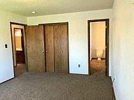 Springfield house for rent - a living room with a carpeted floor and three doors
