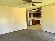 Springfield house for rent - an empty living room with a ceiling fan