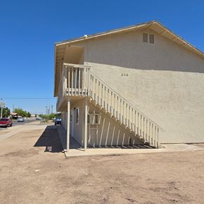 El Centro apartment for rent - A beige building with a staircase leading to the entrance.