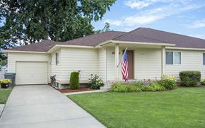 Fairchild Afb apartment for rent - a white house with an flag in the front yard