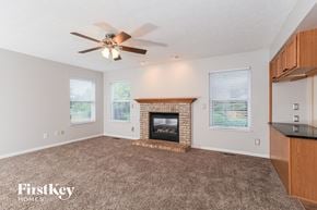 Morrow house for rent - A living room with a fireplace and a ceiling fan.
