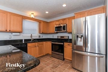 Morrow house for rent - A kitchen with wooden cabinets and a stainless steel refrigerator.