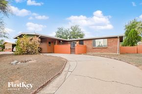 Tucson house for rent - A house with a brown roof and orange walls is for sale.