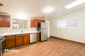 Tucson house for rent - A kitchen with wooden cabinets and a refrigerator.