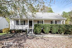 Linwood house for rent - a white house with a front porch and hedges