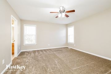 Linwood house for rent - a living room with carpet and a ceiling fan