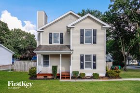 High Point house for rent - a white house with black shutters and a yard with grass and trees