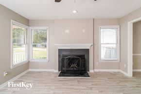 High Point house for rent - a living room with a fireplace and a wooden floor