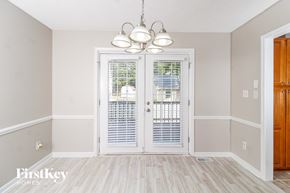 High Point house for rent - a dining room with white doors and a chandelier