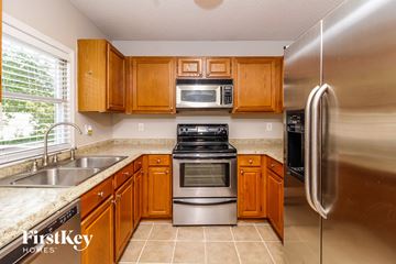 High Point house for rent - a kitchen with stainless steel appliances and wooden cabinets