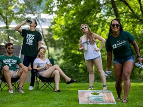 East Lansing apartment for rent - a group of people playing frisbee in a park
