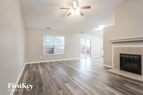 Franklin house for rent - A spacious living room with a fireplace and a ceiling fan.