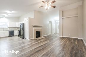 Franklin house for rent - A spacious living room with wood flooring and a fireplace.