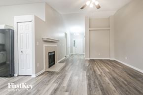 Franklin house for rent - A spacious room with wooden flooring and a ceiling fan.