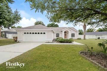 Clermont house for rent - a white house with a driveway and a lawn