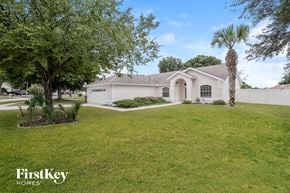 Clermont house for rent - a white house with a lawn and palm tree