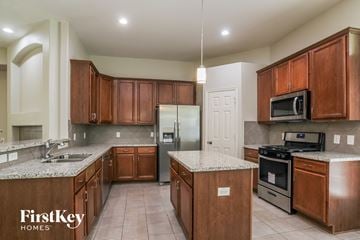 Conroe house for rent - a kitchen with wooden cabinets and stainless steel appliances