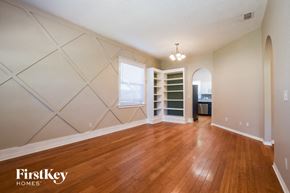 Eustis house for rent - A room with wooden floors and a FirstKey Homes logo.