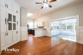 Eustis house for rent - A spacious kitchen with wooden floors and a ceiling fan.