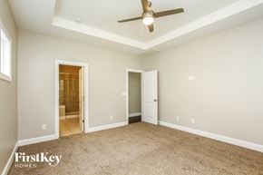 Mooresville house for rent - A spacious room with a ceiling fan and two doors.