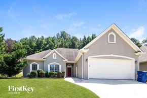 Helena house for rent - A house with a brown roof and a white garage door is shown.