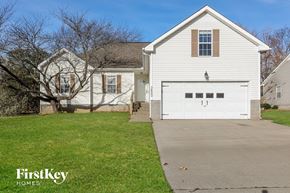 Clarksville house for rent - A white house with a garage door is for sale.