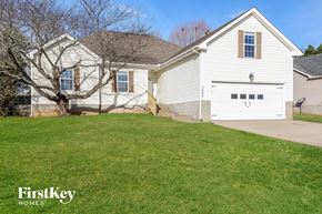 Clarksville house for rent - A white house with a tree in front of it.
