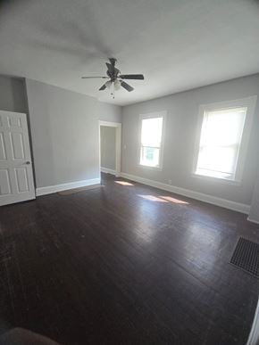 Cincinnati house for rent - A room with a ceiling fan and three windows.