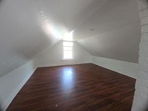 Cincinnati house for rent - A room with wooden floors and a window letting in light.
