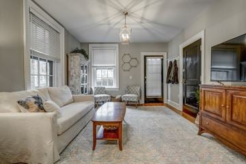 Richmond apartment for rent - A living room with a white couch and a wooden coffee table.