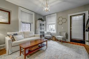 Richmond apartment for rent - A living room with a white couch and a wooden coffee table.