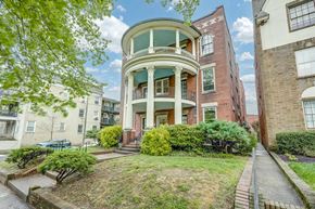 Richmond apartment for rent - A large, multi-story building with a green lawn in front.