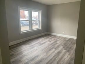 Cleveland apartment for rent - A room with a large window and wood flooring.