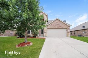 Burleson house for rent - a home with a white garage door and a tree in the yard