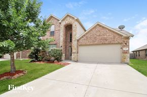 Burleson house for rent - a large brick house with a white garage door