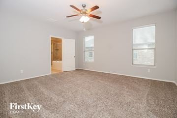 Burleson house for rent - a spacious living room with carpet and a ceiling fan