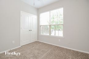 Burleson house for rent - a bedroom with carpet and a window and a door