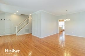 Greensboro house for rent - a living room with a staircase and a hardwood floor