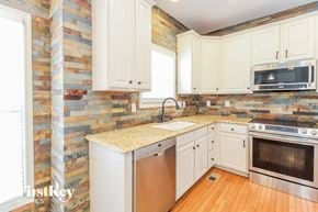 Greensboro house for rent - a kitchen with white cabinets and a counter top