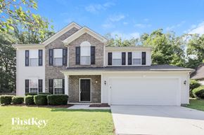Charlotte house for rent - a white house with black shutters and a white garage door