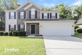 Charlotte house for rent - a white house with black shutters and a white garage door