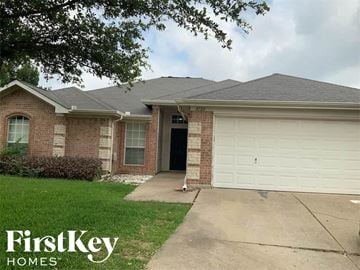 Arlington house for rent - a brick house with a white garage door