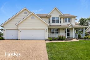 Wentzville house for rent - A two-story house with a garage and a driveway.