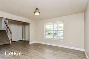 Wentzville house for rent - A room with a staircase and a window.