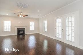 Lexington house for rent - an empty living room with wood floors and a fireplace