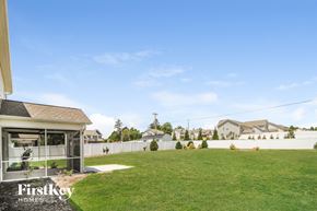 Lexington house for rent - a backyard with a grass lawn and a white fence
